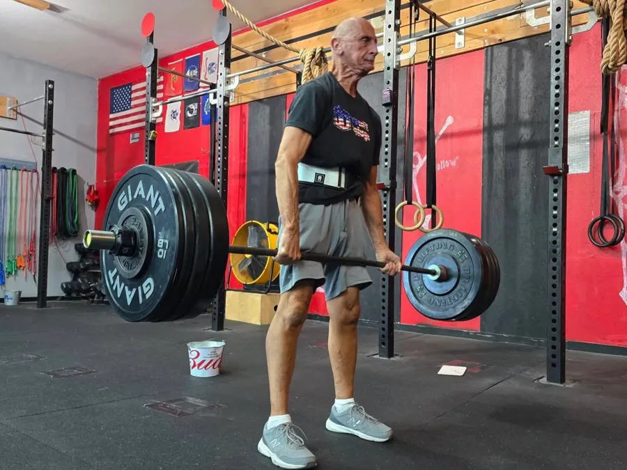 One-on-one personal training session showing coach helping athlete with proper form and technique