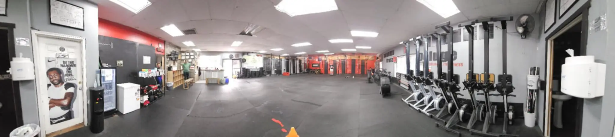 Wide panoramic view of CrossFit Deluge gym interior showing the full training space, equipment, and welcoming atmosphere